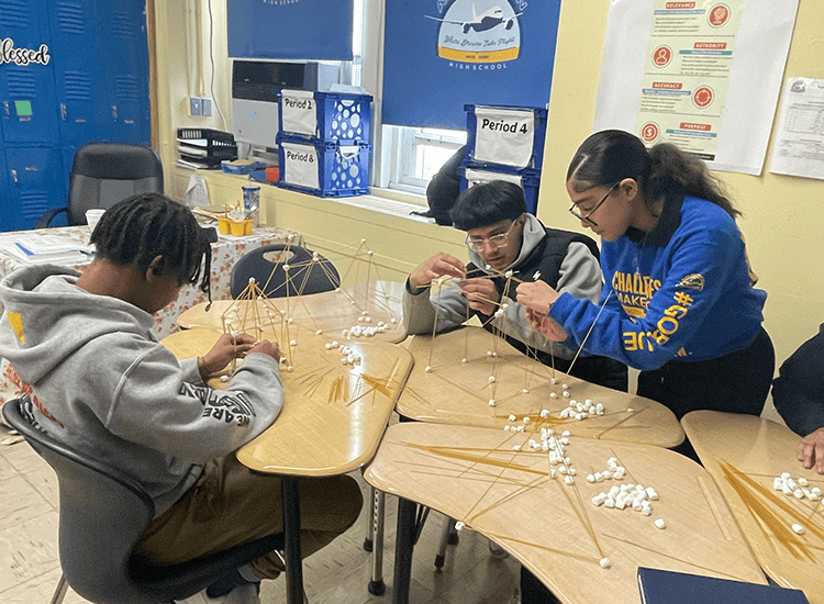 Students creating structures with spaghetti and marshmellows
