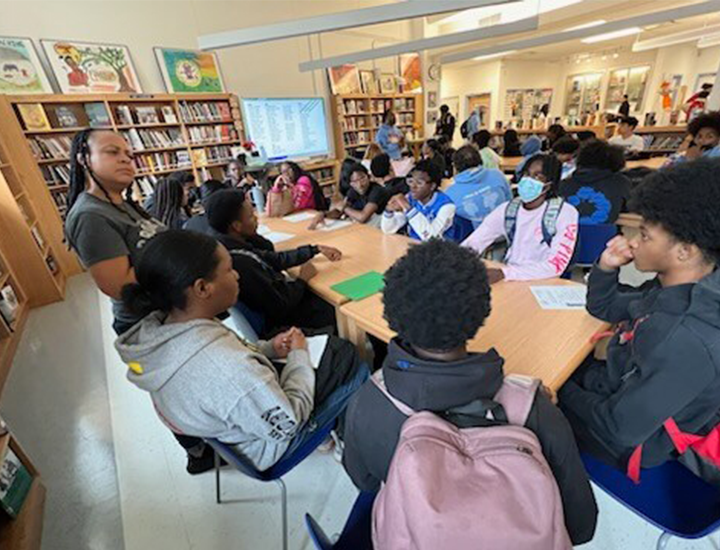 Students sitting around a table in the library